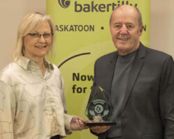 Connie Brown from Parkland College presents the Award of Excellence to D's Signs & Designs